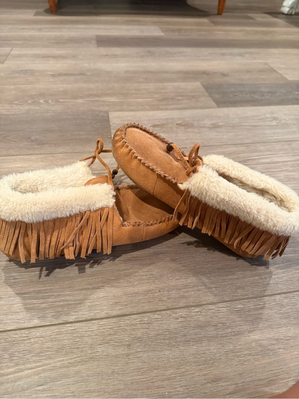 Minnetonka Kids Fringe Moccasin Slippers in Tan with Cream Lining